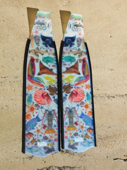 Colorful fish-shaped fins with a pattern on a beige surface