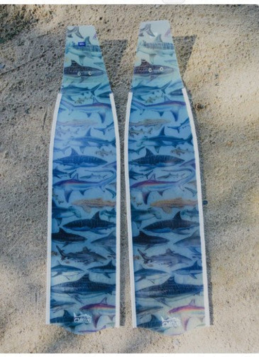 Two fins with shark pattern design on a textured surface